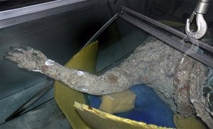 An image of a handout photo provided by the Greek Ministry of Culture on Monday, March 23, 2009, the torso and raised right arm of a 2,200-year-old statue are seen after it was raised in a fisherman's nets. The ministry said the find, dated to the late 2nd century B.C.. This image is also a clickable link direct to The News & Observer story