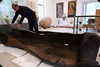 an image of archaeologist Dimitar Nedkov, measuring the length of the ancient vessel found in the Black Sea, which is also a clickable link to the Press TV story