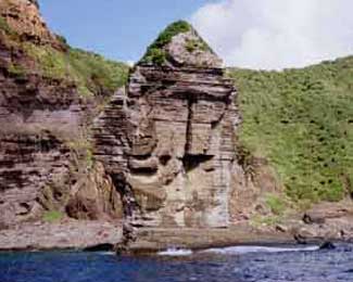 an image of the coastal Tategami-iwa figure as seen from the sea, where its eroded features show what appears to be the outline of a human face