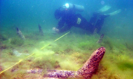an image showing a diver at the underwater ruins of a lost city found off the coast of Montenegro, which is also a clickable link direct to The Local, Germany, news story