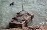 an image showing a sunken red granite tower, part of a pylon of the Isis temple is lifted out of the Mediterranean Sea off the archaeological eastern harbor of Alexandria, which is also a clickable link direct to the AP News story