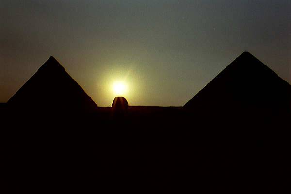 Sunset over the Great Sphinx between the pyramids of Khafre and Khufu