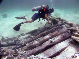 an image of the hull remains of the so-called 'Black Rock Wreck' discovered off East Caicos, which is also a clickable link to the NOAA, USA story